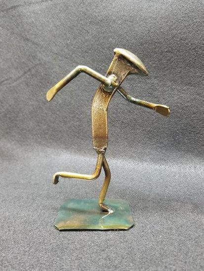 runner in mid running action shot metal spike art product photo