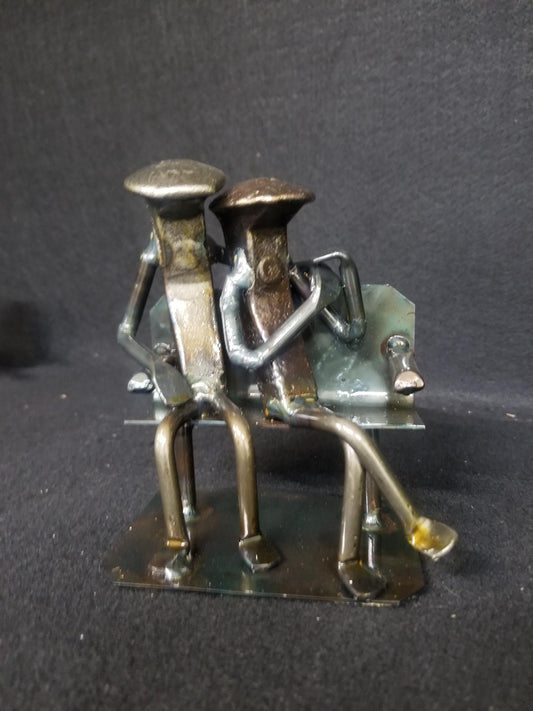 Base variation of couple sitting on bench metal spike art product