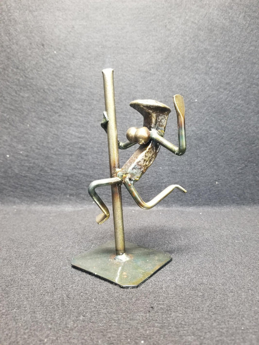 Exotic Dancer swinging with one hand on the pole metal spike art product photo