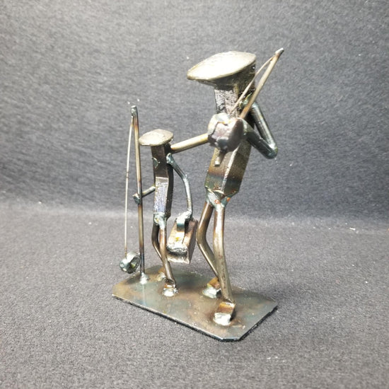 Two fisherman holding shoulders with fishing poles metal spike art product photo