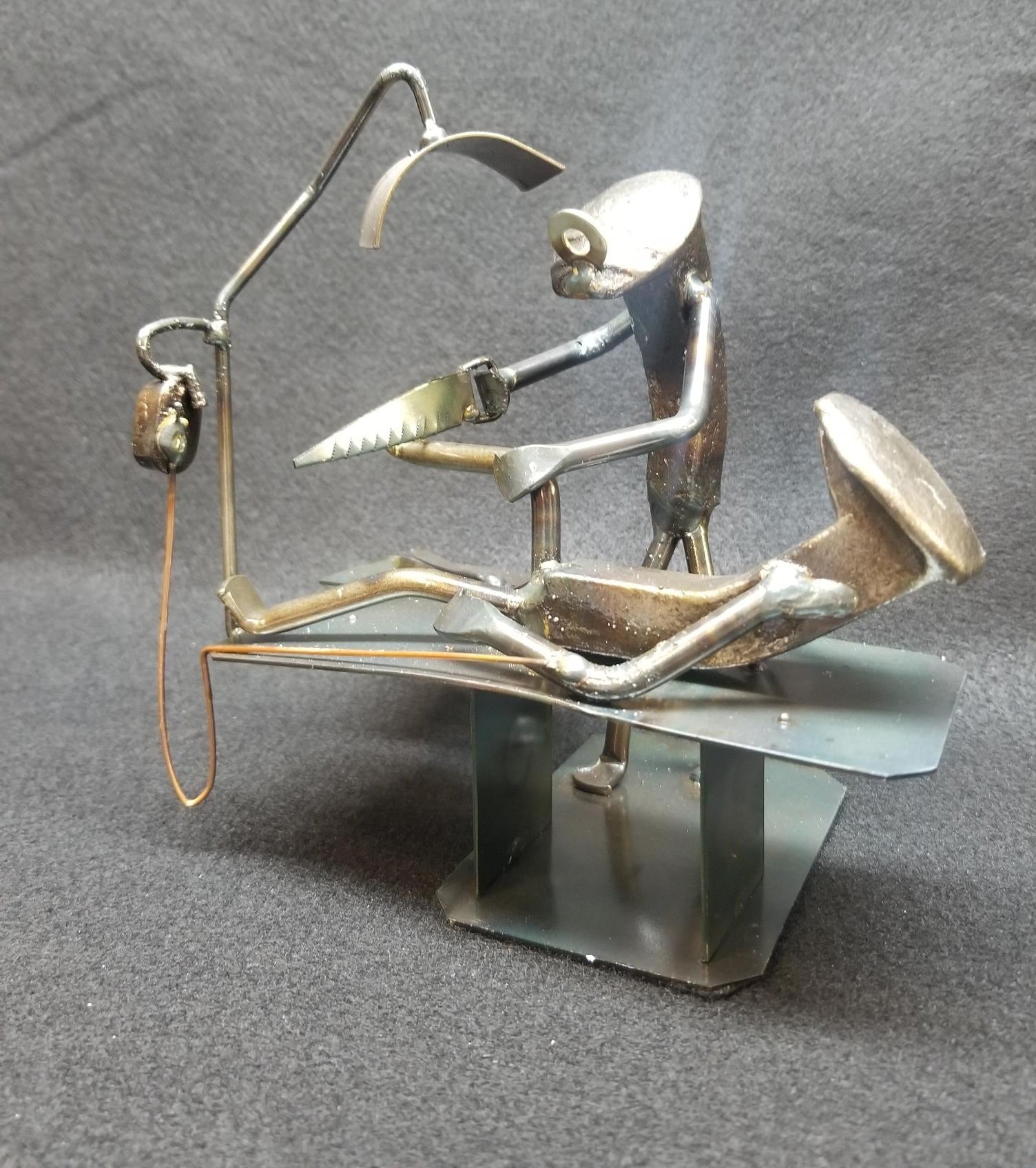 Foot Surgeon operating on patient on table metal spike art
