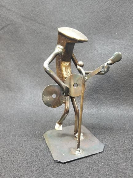 Musician playing guitar standing up metal spike art product photo