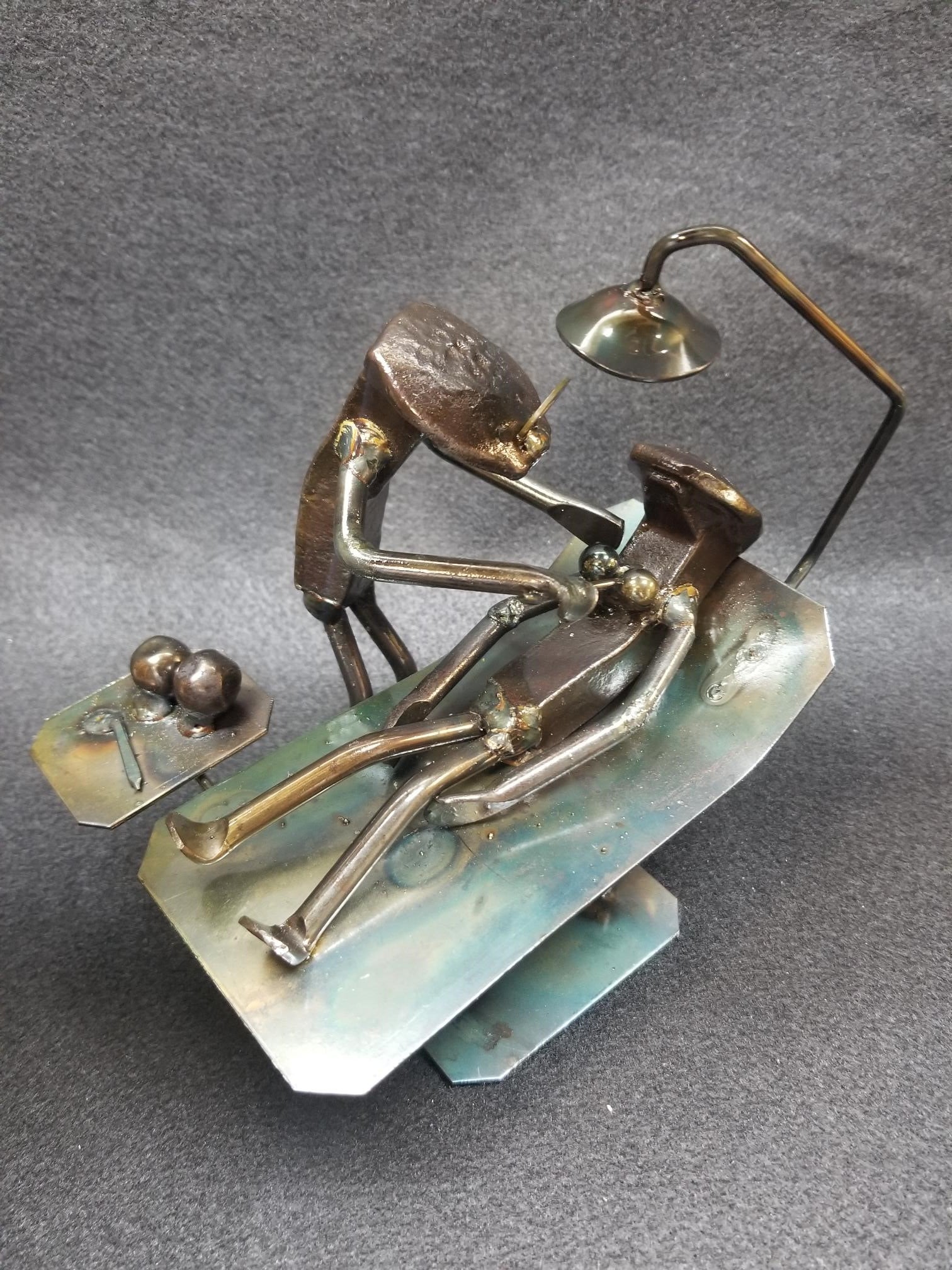 Plastic Surgeon working on patient on operating table metal spike art