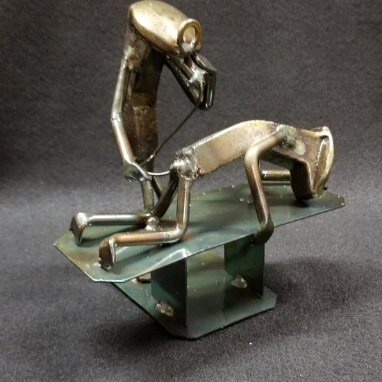 proctologist with the patient on the table with a tube in their rear end metal spike art product photo