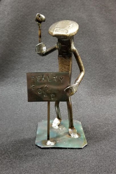 Realtor stamping sign into ground metal spike art product photo