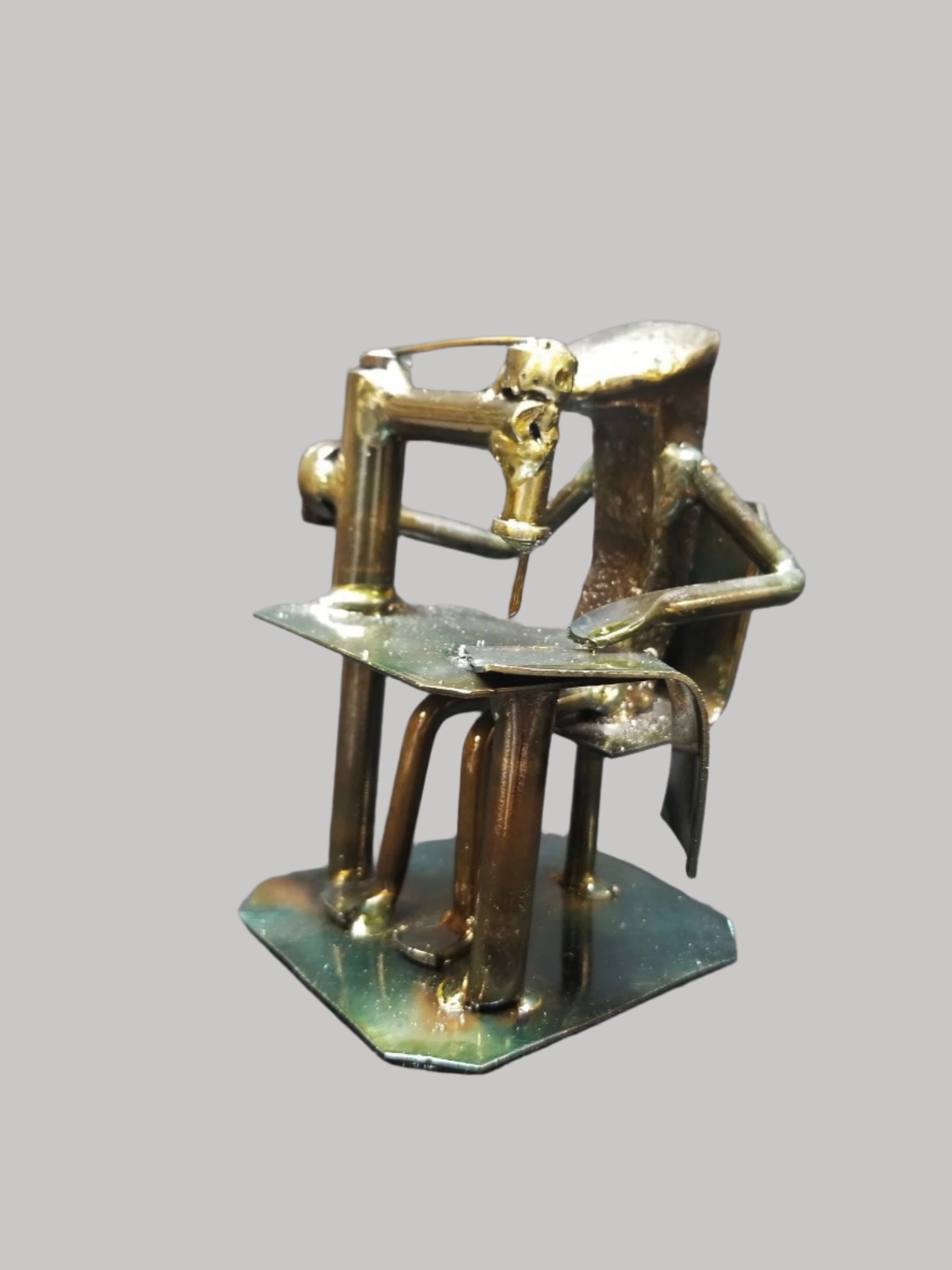 seamstress sitting at desk with their sowing machine metal spike art product photo