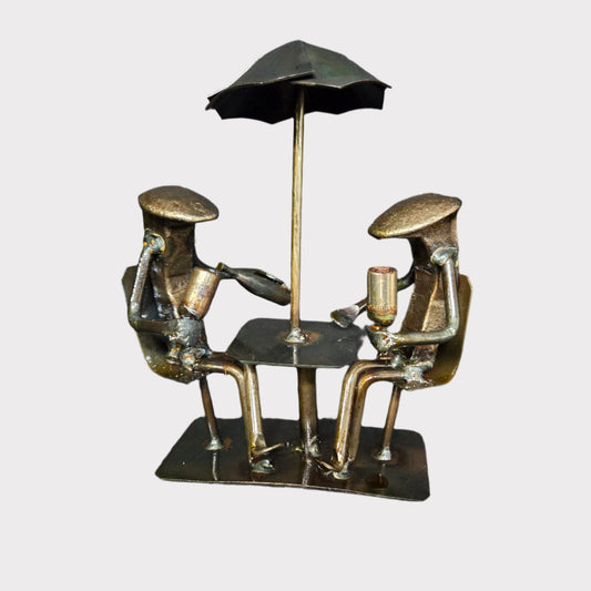 Wine Time is approximately 7 inches tall.
Two figures seated under an umbrella, "Pouring Wine". Each model is made uniquely; minor details will vary.