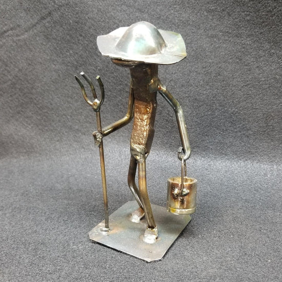 Farmer holding pitchfork metal spike art product photo