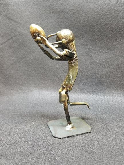 Football player holding football above their head in running motion metal spike art product photo