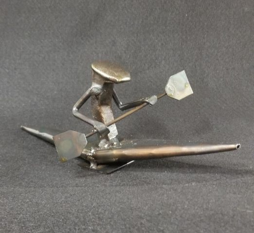 kayak with spike person in holding the paddle metal spike art product photo