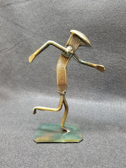 runner in mid running action shot metal spike art product photo