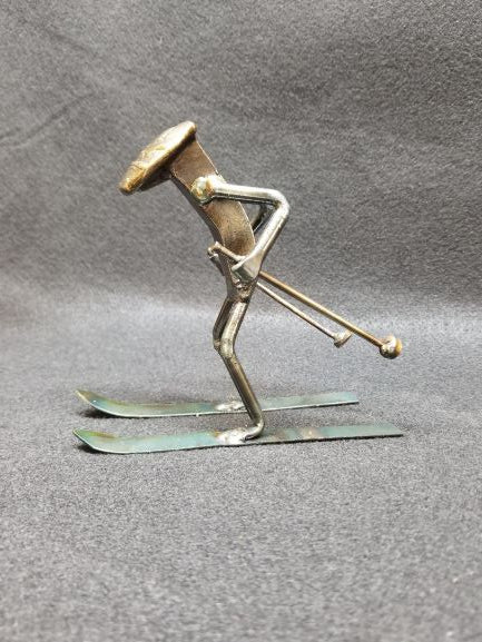 skier in their skies with ski poles in hand metal spike art product photo
