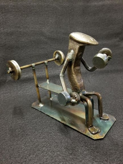 weightlifter sitting at bench with dumbbell in hand metal spike art product photo