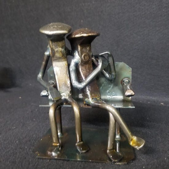 Base variation of couple sitting on bench metal spike art product