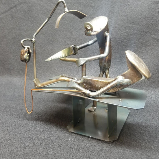 Foot Surgeon operating on patient on table metal spike art