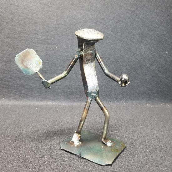 pickleball player holding paddle and ball metal spike art product photo