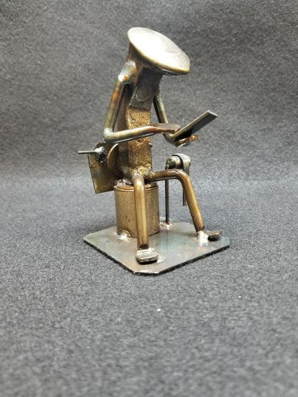 Spike person sitting on the toilet scrolling on their phone metal spike art product photo