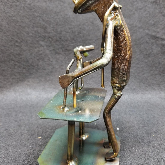 vet standing at table with dog ontop metal spike art product photo